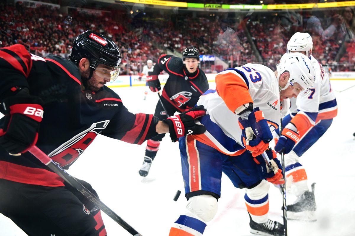 Defenseman Shayne Gostisbehere battles an opponent for the puck during the game versus the New York Islanders at the Lenovo Center on Sunday, March 30, 2025. The Hurricanes beat the Islanders 6-4.