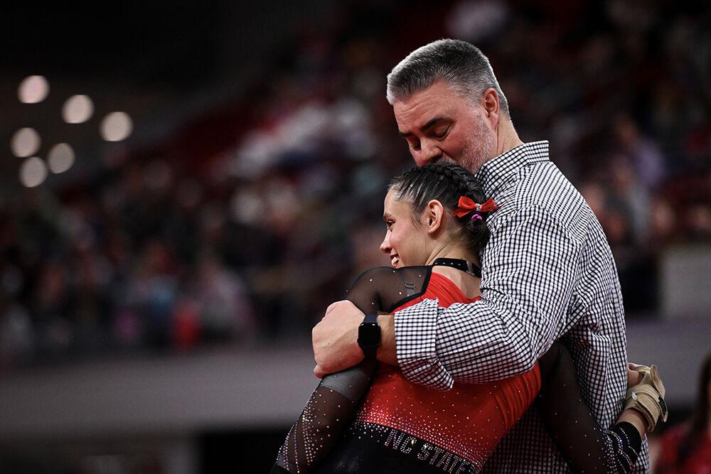 Graduate student Chloe Negrete hugs assistant coach Bob Starkell during the meet against Ohio State in Reynolds Coliseum on Friday, March 7, 2025. Negrete scored 9.850 on the vault, 9.975 on the balance beam, and 9.975 in the floor exercise. NC State beat Ohio State 197.000-196.325.