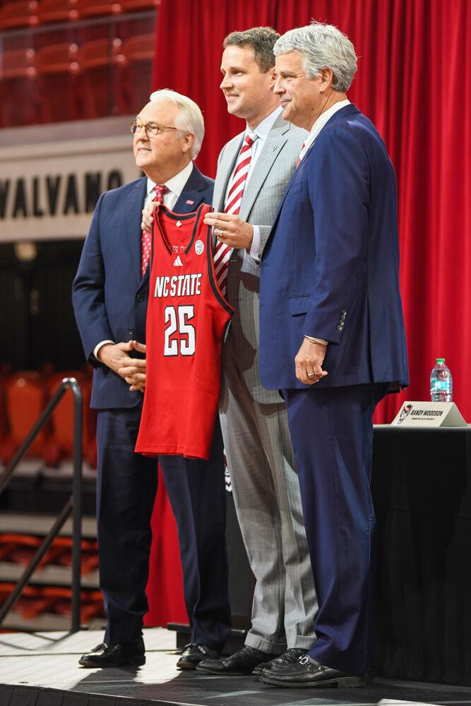(From left to right) Randy Woodson, chancellor of NC State, Will Wade, the new head coach of NC State men's basketball, and Boo Corrigan, McMurray Family Director of Athletics, pose for a photo during a press conference discussing the hiring of Wade inside Reynolds Coliseum on Tuesday, March 25, 2025. Wade is the Wolfpack's 21st men's basketball coach, following after former coach Kevin Keatts.