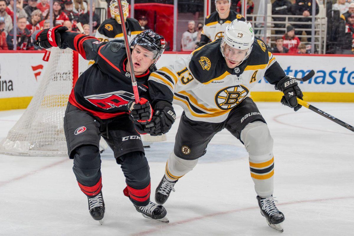 Forward Jackson Blake challenges the puck with a defender during the game against the Boston Bruins at the Lenovo Center on Saturday, March 6, 2025. Blake had one shot on goal. The Hurricanes beat the Bruins 3-2.