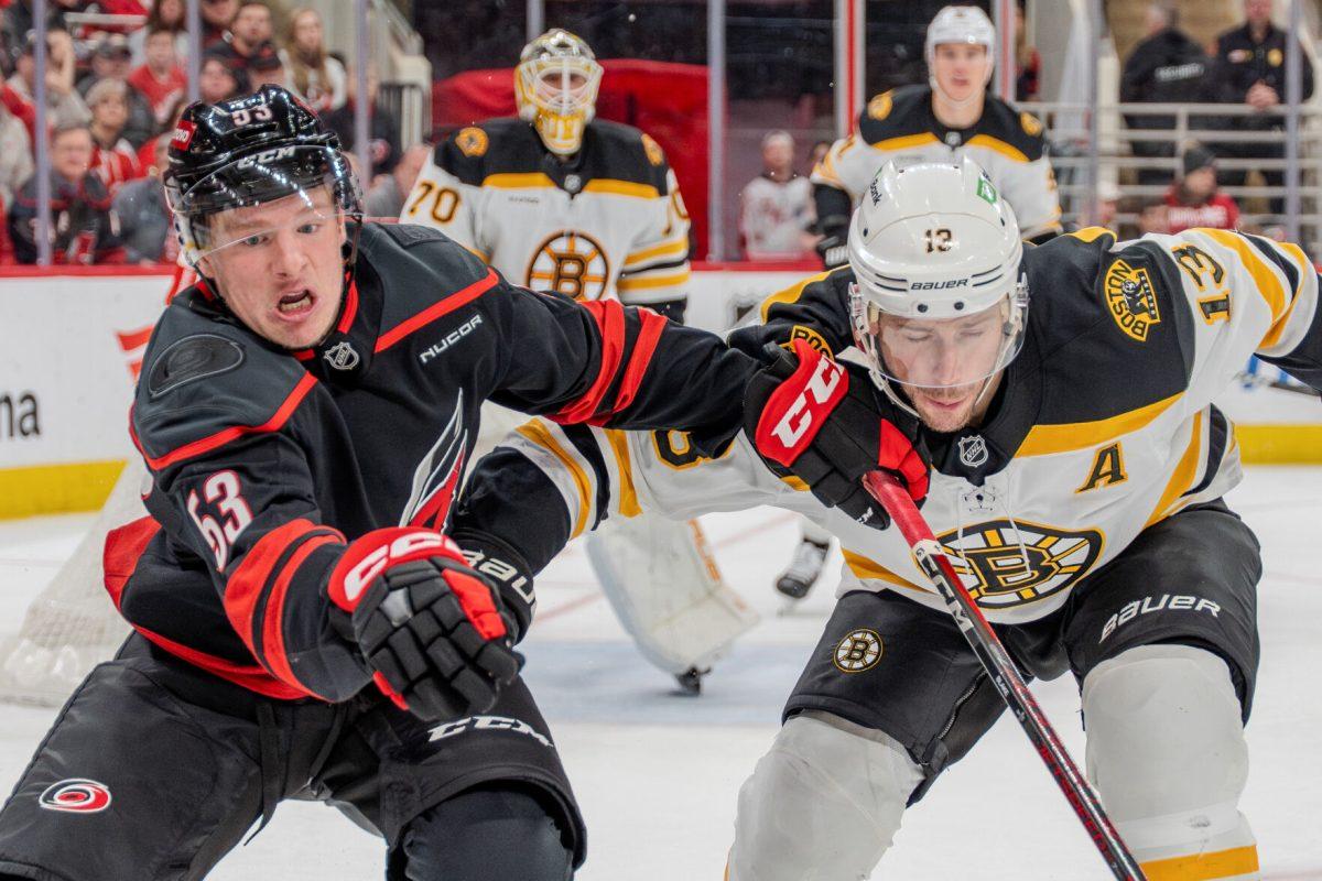 Forward Jackson Blake challenges the puck with a defender during the game against the Boston Bruins at the Lenovo Center on Saturday, March 6, 2025. Blake had one shot on goal. The Hurricanes beat the Bruins 3-2.
