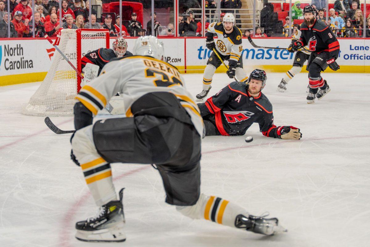Boston center Morgan Geekie strikes the puck during the game against the Carolina Hurricanes at the Lenovo Center on Saturday, March 6, 2025. Geekie had four shots on goal. The Hurricanes beat the Bruins 3-2.