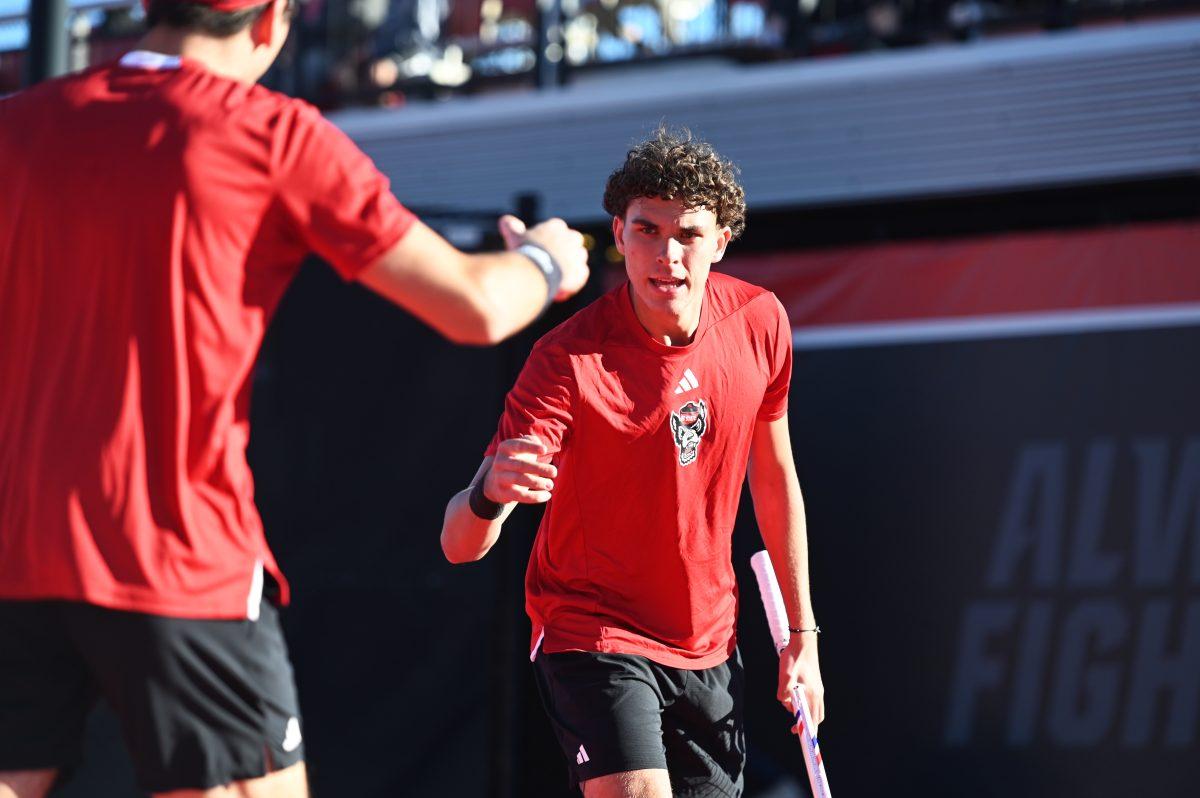 Redshirt freshman Jules Leroux celebrates with senior Luca Staeheli during their doubles match versus Cal at J.W. Isenhour tennis center on Friday, Feb. 28, 2025. Leroux and Staeheli's doubles match was unfinished. The Wolfpack beat the Golden Bears 4-2.