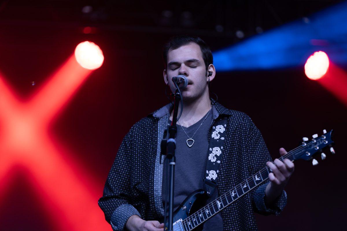Lead singer of Pilot Light Sam Coury closes his eyes as he sings during Wolfstock on Miller Fields on Saturday, April 12, 2025. Pilot Light is a recently formed band made up of Coury, Ethan Johnson, Mason Stark and Chaandmon.