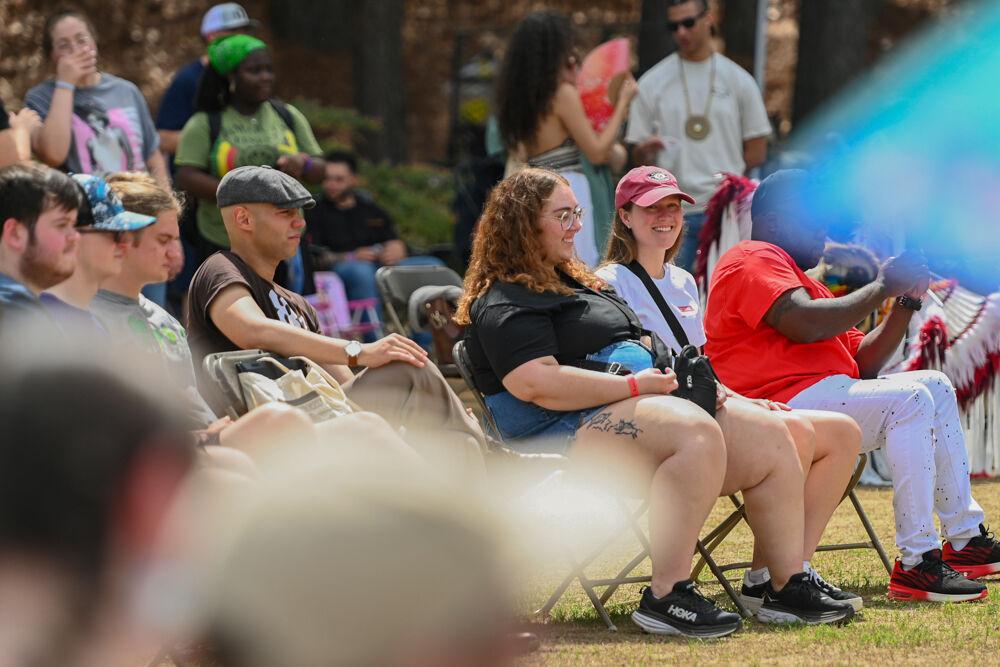Visitors gather in a circle of chairs to watch a display of different Indigenous dance styles during NC State's 35th Annual Powwow at Miller Fields on Saturday, April 5, 2025. The event featured various Native vendors, different Indigenous dance performances and traditional drum groups.