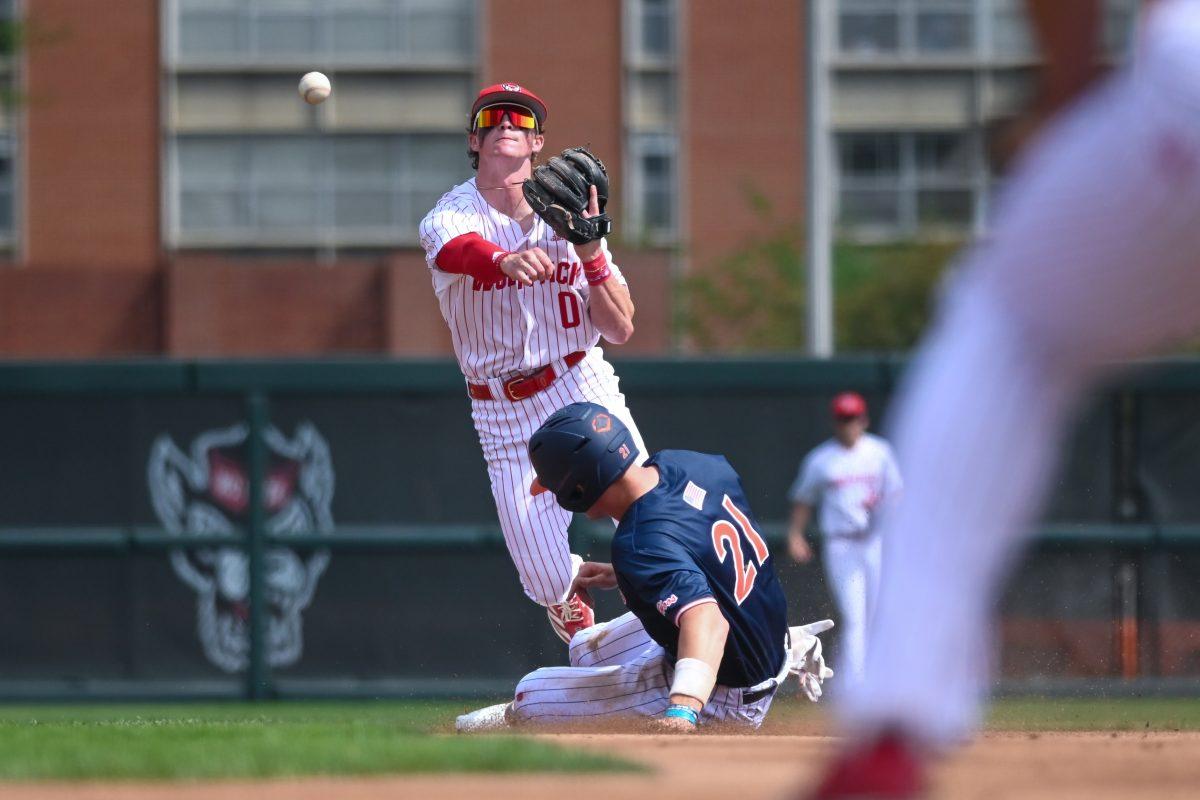Sophomore infielder Luke Nixon throws to first for a double play during the game against Virginia on April 5, 2025 at Doak Field at Dail Park. Nixon went three for three and one walk. NC State bested Virginia 9-2.
