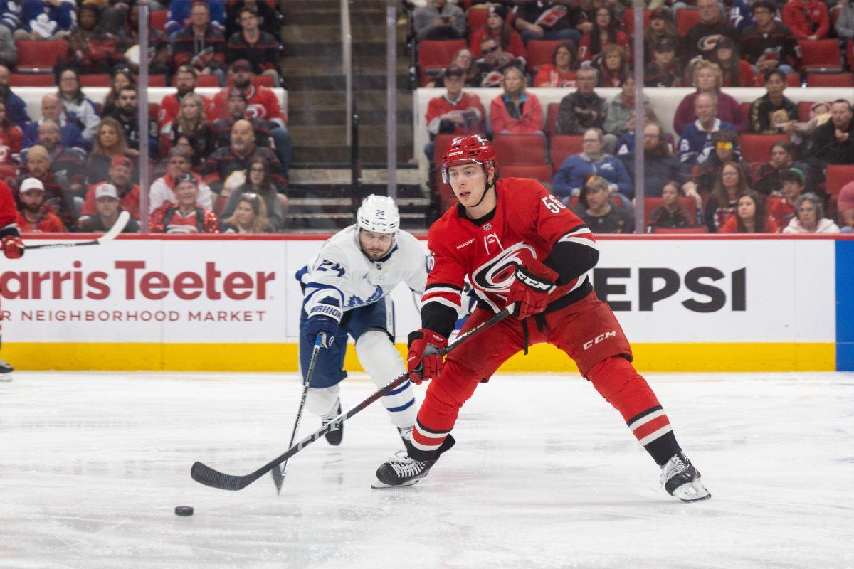 Defenseman Scott Morrow passes the puck during the game versus the Toronto Maple Leafs at the Lenovo Center on Sunday, April 13, 2025. The Hurricanes lost to the Maple Leafs 4-1.