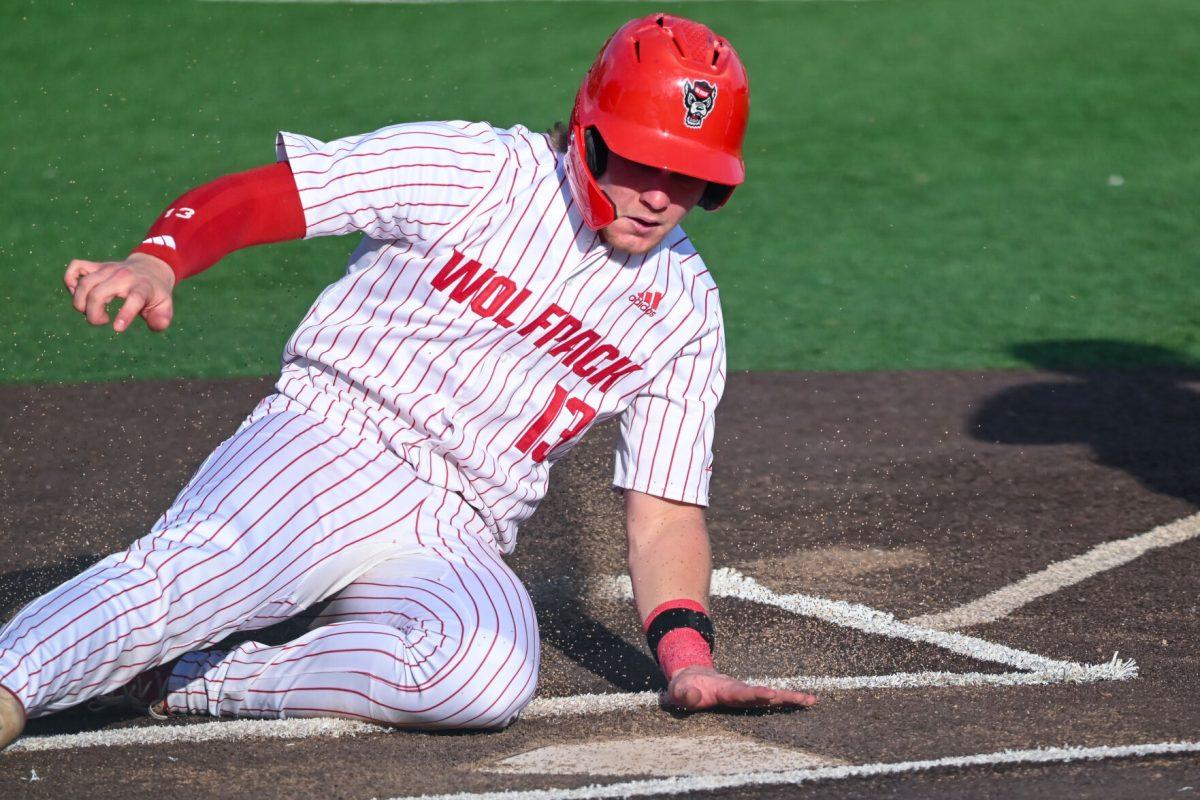 Freshman catcher Alex Sosa slides home during the game against Virginia on April 5, 2025 at Doak Field at Dail Park. Sosa had one run and two walks. NC State bested Virginia 9-2.