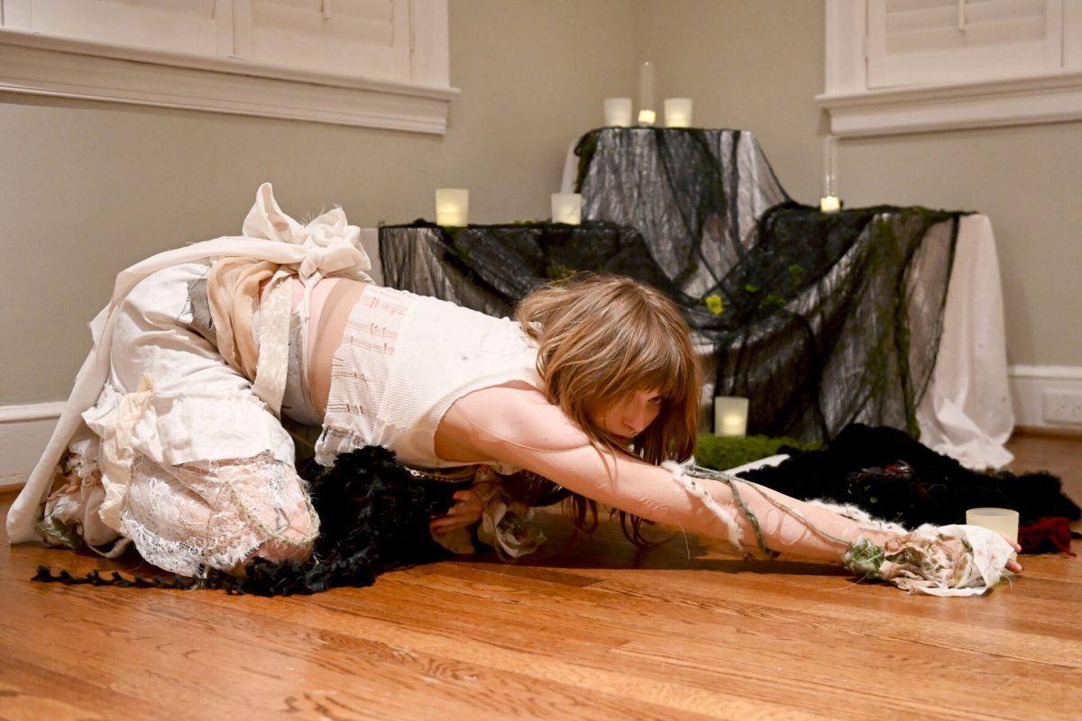 Alyx Hucks, a fourth-year studying sociology and graphic and experience design, crawls while performing her design "'Til Mourning Comes" during the Art2Wear: Revive! show at the Gregg Museum of Art and Design on Thursday, April 24, 2025. Hucks&#8217; crocheted piece follows the transformation of a mortal overtaken by a banshee, and is dedicated to her grandmother.