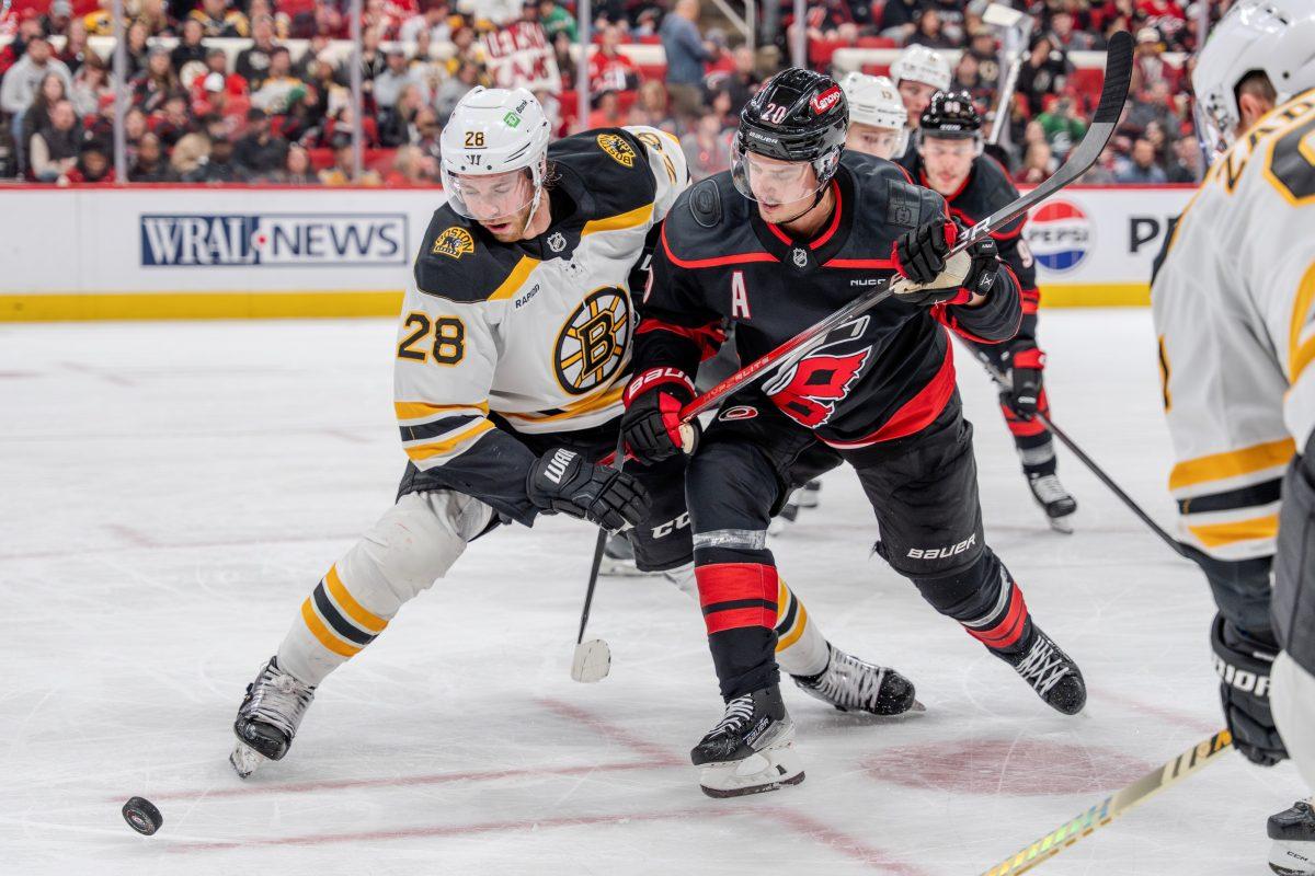 Boston center Elias Lindholm challenges the puck after a faceoff during the game against the Carolina Hurricanes at the Lenovo Center on Saturday, March 6, 2025. Lindholm had three shots on goal. The Hurricanes beat the Bruins 3-2.