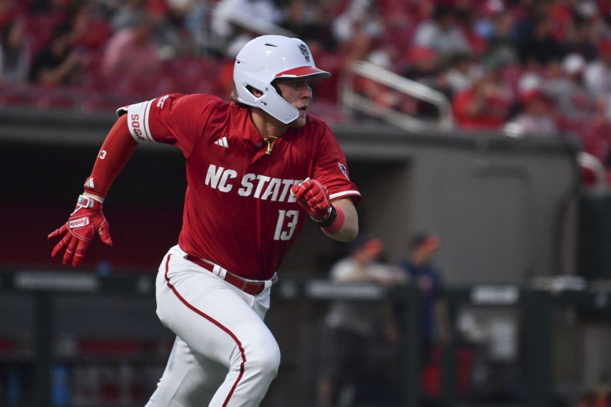 Sophomore catcher Alex Sosa runs to first after a hit during the Wolfpack's home game against the Virginia Cavaliers on Doak Field at Dail Park on Friday, April 4, 2025. Sosa had one hit for one run and one runner batted in. The Cavaliers beat the Wolfpack 8-6 to take the first game of the series.