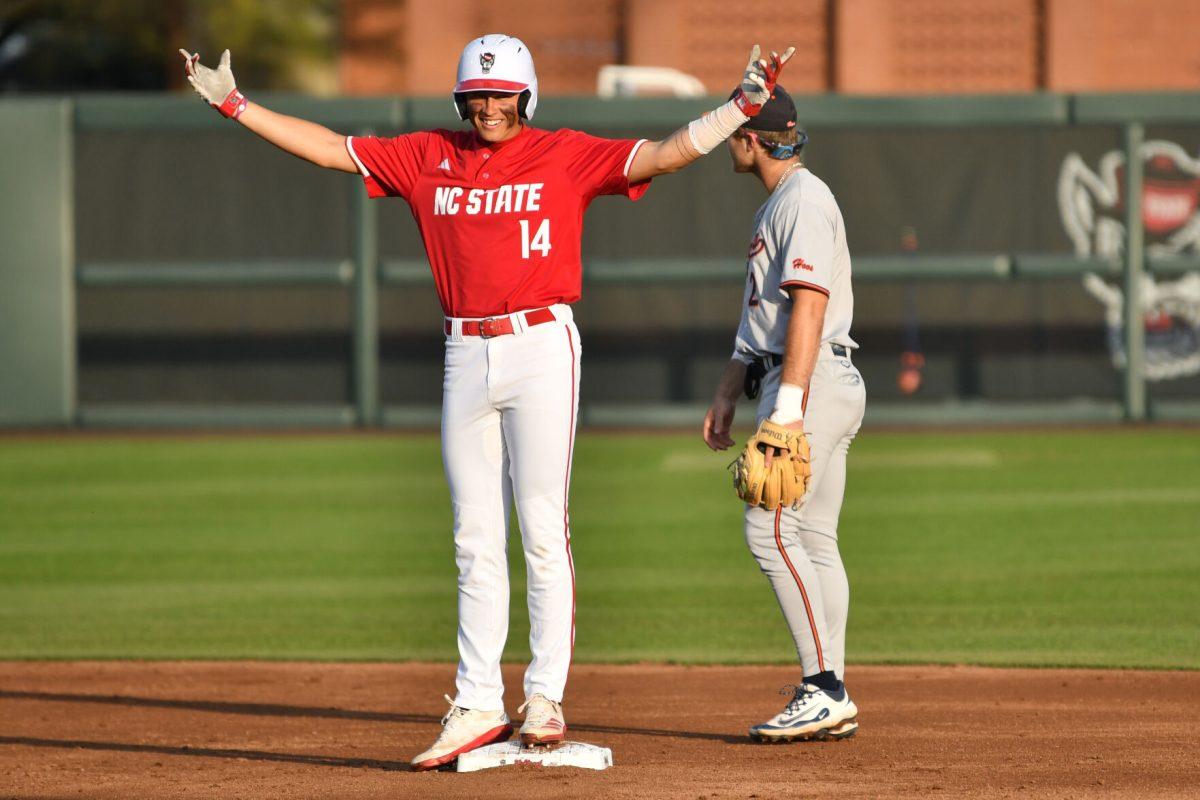 Freshman outfielder Ty Head celebrates making it to second base after an error by the Virginia infield during the Wolfpack's home game against the Virginia Cavaliers on Doak Field at Dail Park on Friday, April 4, 2025. Head stole a home run and hit twice and was walked twice on four at bats. The Wolfpack lost to the Cavaliers 8-6.