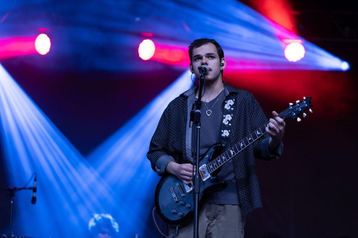 Lead singer of Pilot Light Sam Coury looks out at the crowd as he sings during Wolfstock on Miller Fields on Saturday, April 12, 2025. Pilot Light is a recently formed band made up of Coury, Ethan Johnson, Mason Stark and Chaandmon.