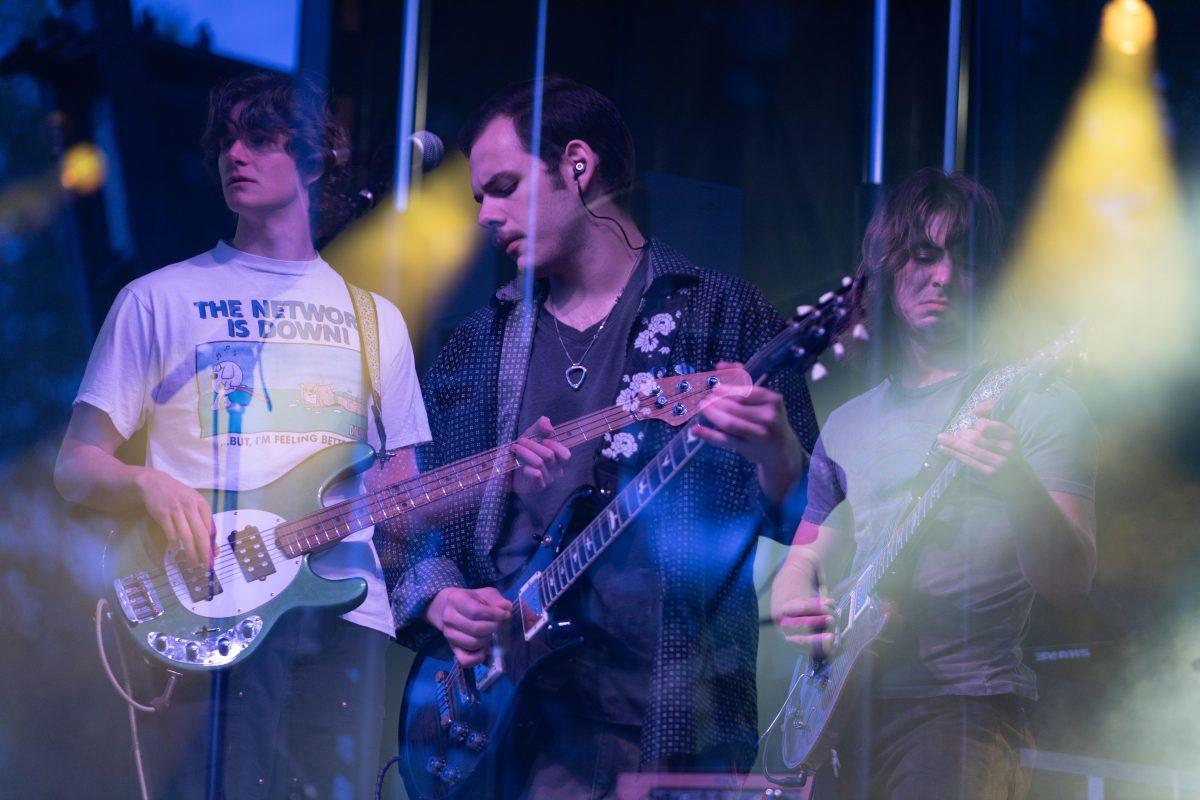 Members of Pilot Light Ethan Johnson, Sam Coury and Mason Stark play during Wolfstock on Miller Fields on Saturday, April 12, 2025. Pilot Light opened for indie band Peach Tree Rascals.