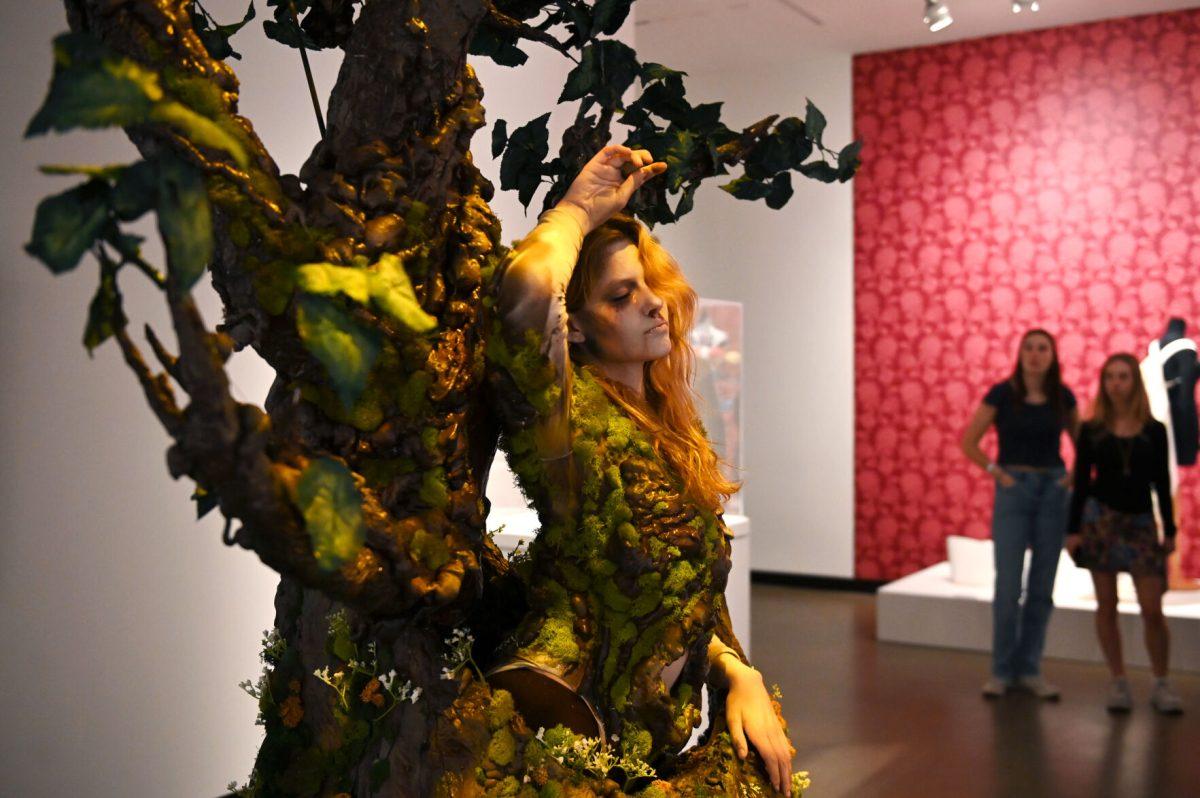 Bailey Lawson, a second-year studying graphic and experience design, rests against the tree while modeling &#8220;The Return Home&#8221; by Mia Danford-Klein, a third-year studying media arts, design, and technology during the Art2Wear: Revive! show at the Gregg Museum of Art and Design. &#8220;The Return Home&#8221; is a tribute to the cycle of life, death, and rebirth, and explores the balance between life&#8217;s fragility and strength using elements of nature.