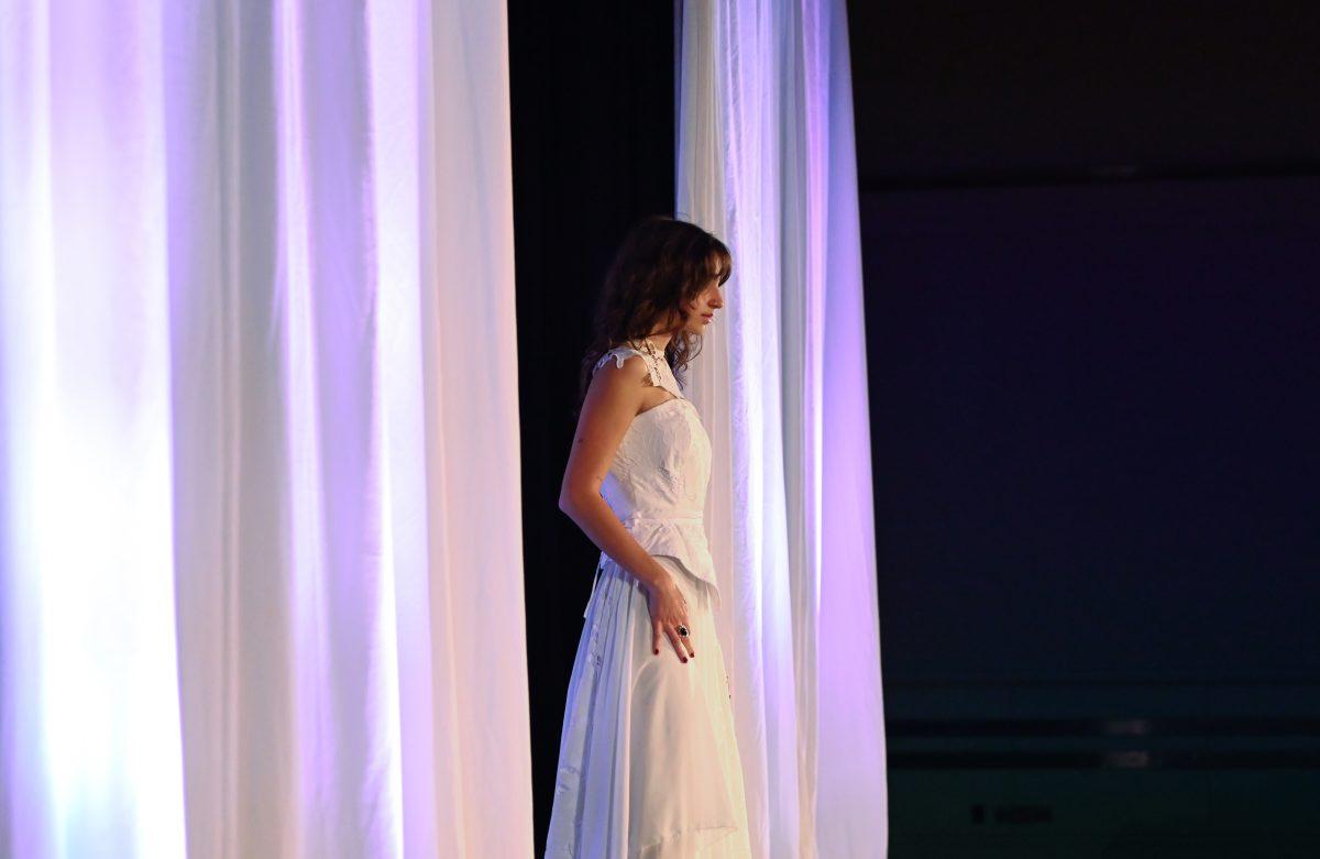 A model stands at the top of the runway in a piece designed by Grace Chen, a second-year studying fashion and textile design, as part of her collection, "In the Midst Of," during the 27th Annual Fashion Expose at Talley Student Union on Thursday, April 10, 2025. Students showcased their hard work from the semester in front of a panel of judges.