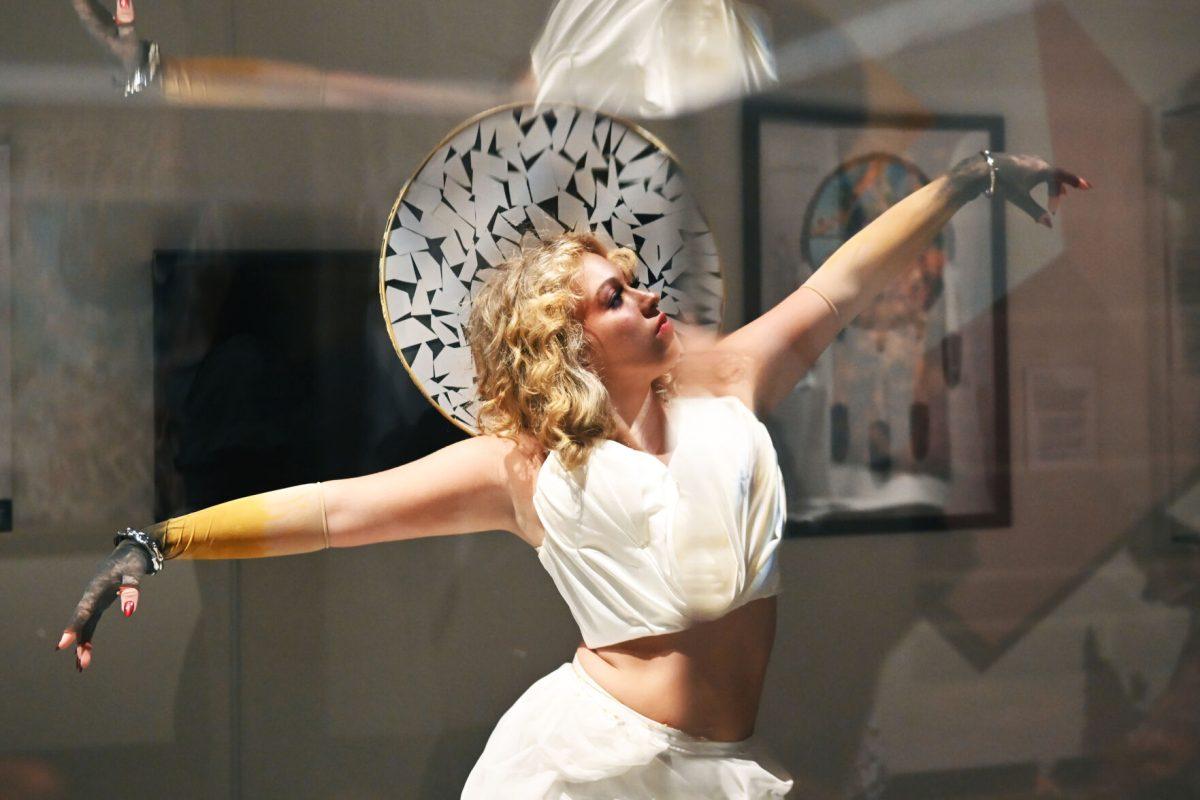 Alli Jo LaFevers, a third-year studying fashion and textile design, performs &#8220;The Fall Of Icarus&#8221; designed by Mia Potter and Devyn Williams during the Art2Wear: Revive! show at the Gregg Museum of Art and Design on Thursday, April 24, 2025. Potter and Williams&#8217; designs were inspired by ancient Greco-Roman art and clothing, as well as medieval garment construction, ballet, and masquerade.