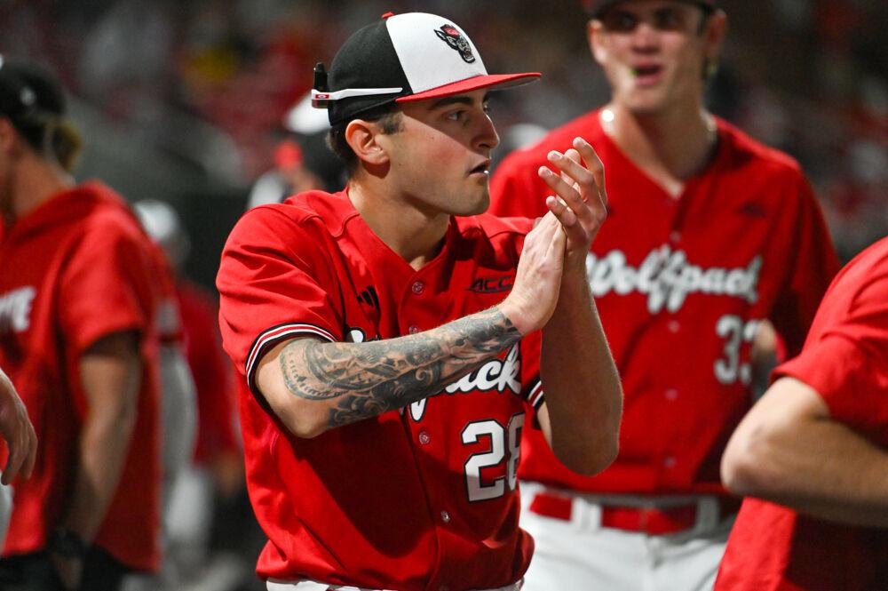 Sophomore pitcher Cooper Consiglio claps by the dugout during the game against UNC-Greensboro&#160;on Doak Field at Dail Park on Tuesday, April 1, 2025. The Wolfpack defeated the Spartans 9-6.