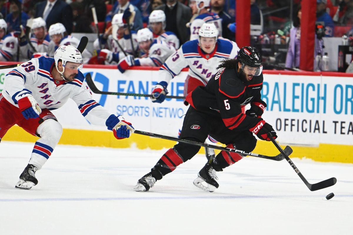 Defenseman Jalen Chatfield gets control of the puck during the game versus the New York Rangers at the Lenovo Center on Saturday, April 12, 2025. Chatfield scored one goal for the Hurricanes. The Hurricanes beat the Rangers 7-3.