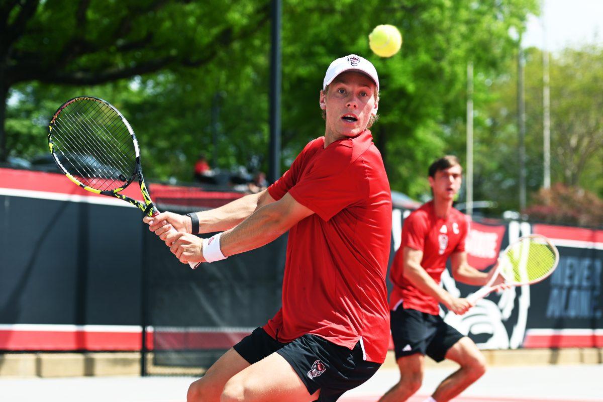 Senior Fons Van Sambeek prepares to return the ball during his doubles match with senior Braden Shick versus SMU at J.W. Isenhour Tennis Center on Sunday, April 6, 2025. Shick and Van Sambeek won their doubles match 7-6. The Wolfpack beat the Mustangs 4-1.
