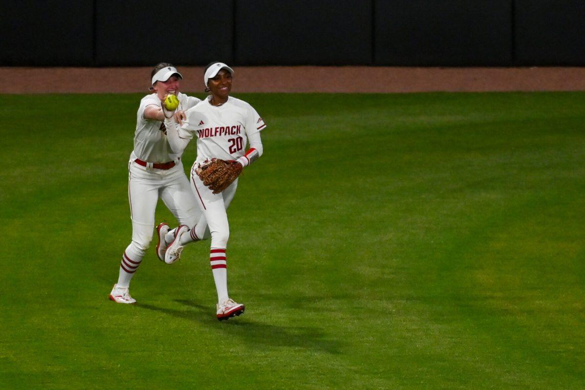 Junior utility player MaKayla Marbury (right) and junior outfielder Ellie Goins (left) run back to the dugout after Marbury caught a hit during the game against Virginia Tech at Dail Softball Stadium on Friday, April 5, 2025. The Wolfpack lost to the Hokies 10-2.