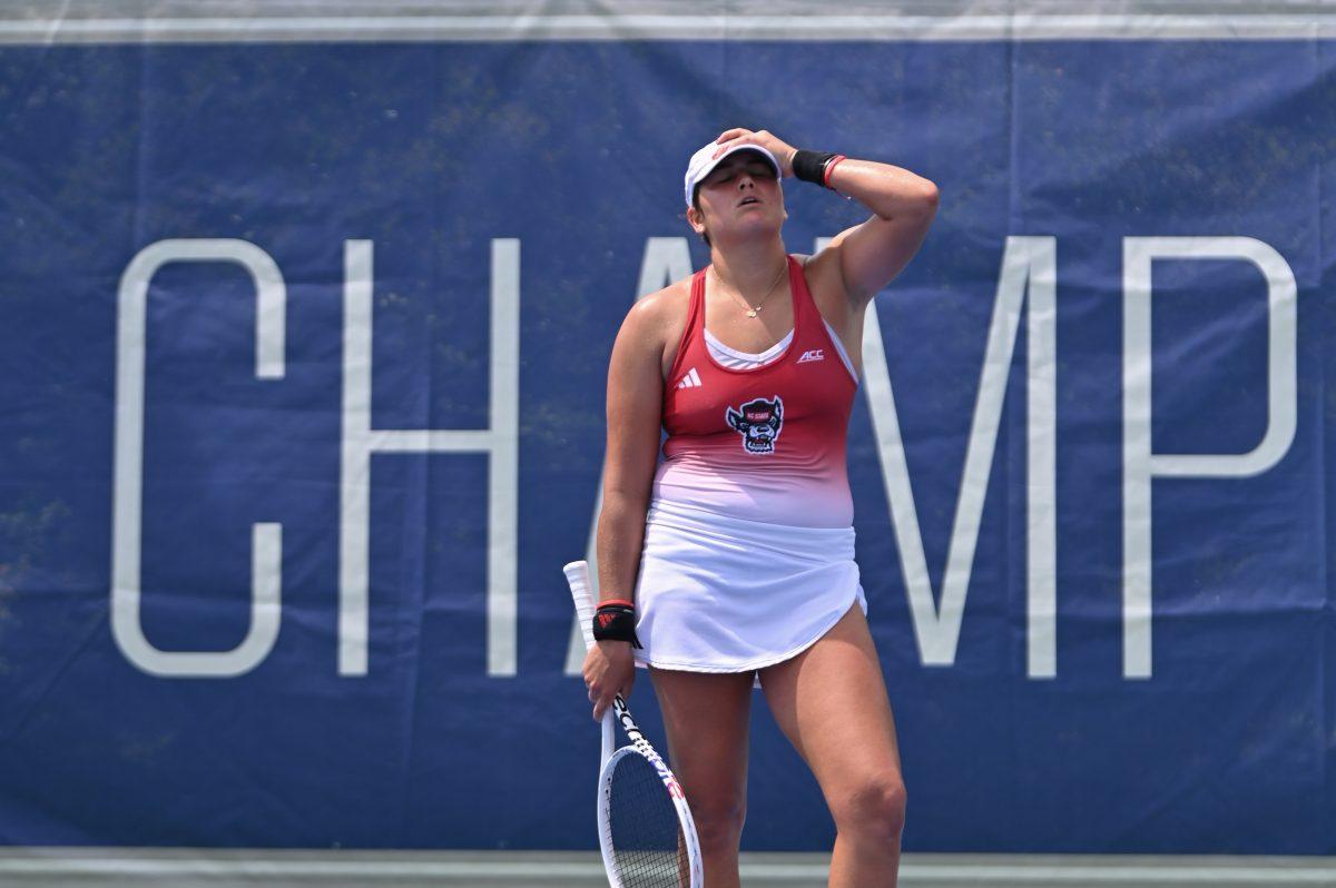 Freshman Mia Slama holds her head in disappointment during the ACC semifinals match against UNC-Chapel Hill at Cary Tennis Park on Saturday, April 19, 2025. The Wolfpack fell to the Tar Heels 4-1.&#160;