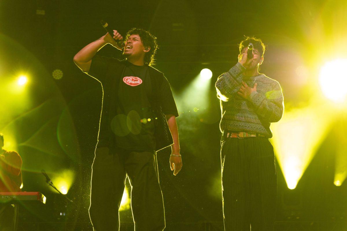 Members of Peach Tree Rascals Joseph Barros and Tarrek Abdel-Khaliq close their eyes as they sing to the crowd during Wolfstock on Miller Fields on Saturday, April 12, 2025. The band went viral with their song "Mariposa" in 2019.