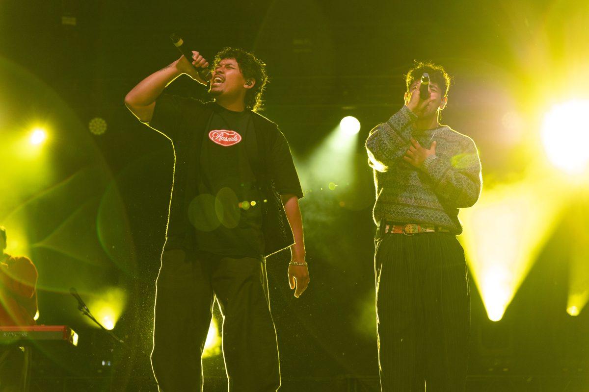 Members of Peach Tree Rascals Joseph Barros and Tarrek Abdel-Khaliq close their eyes as they sing to the crowd during Wolfstock on Miller Fields on Saturday, April 12, 2025. The band went viral with their song "Mariposa" in 2019.