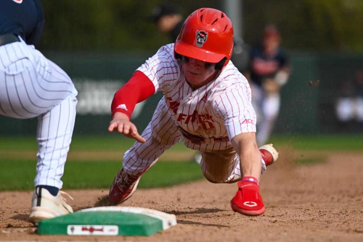 Sophomore infielder Luke Nixon slides back to first during the game against Virginia on April 5, 2025 at Doak Field at Dail Park. Nixon went three for three with one walk NC State beat Virginia 9-2.