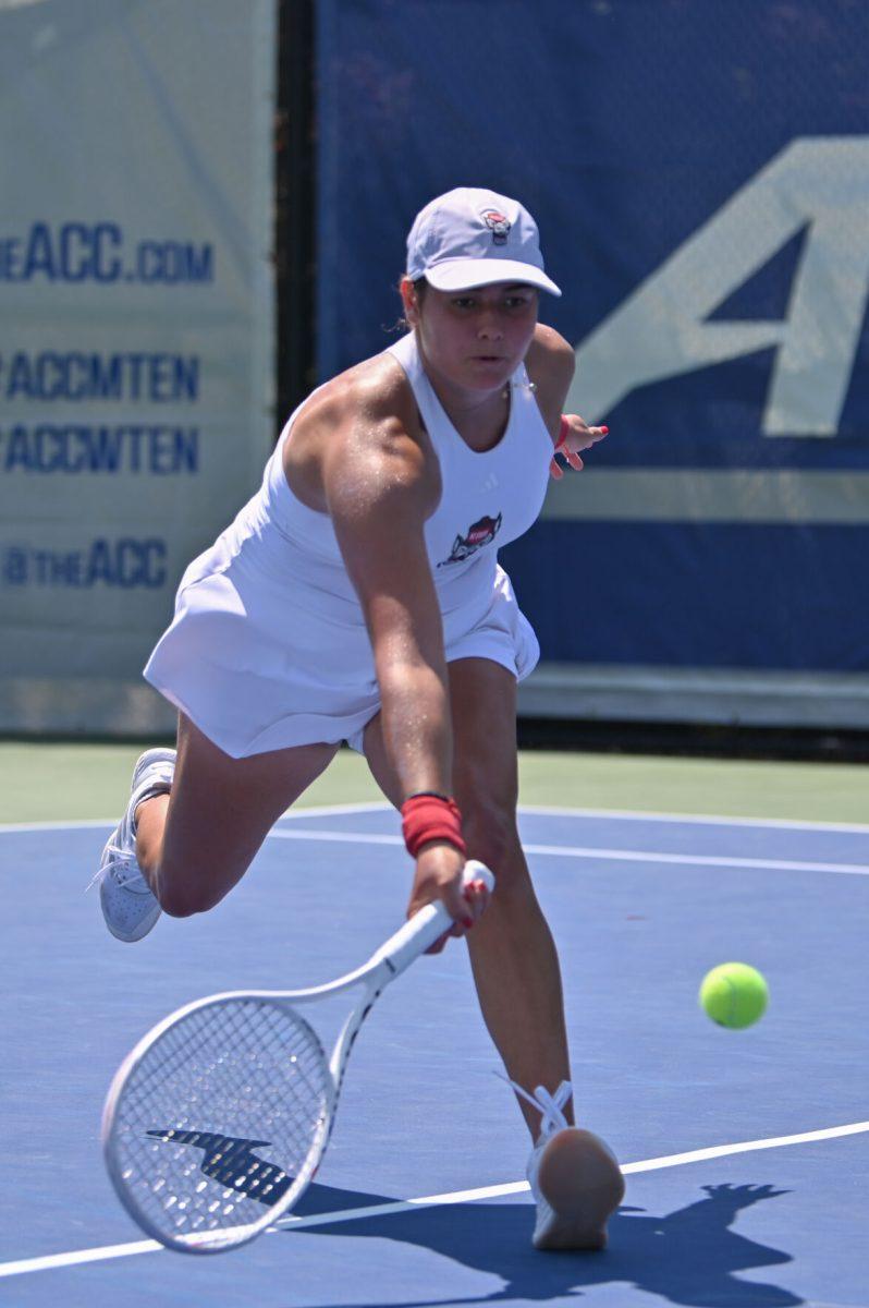 Freshman Mia Slama lunges for a low ball during the quarterfinal match of the ACC Championship against Notre Dame at Cary Tennis Park on Friday, April 18, 2025. Slama won her singles match 2-0. The Wolfpack defeated the Fighting Irish 4-1.