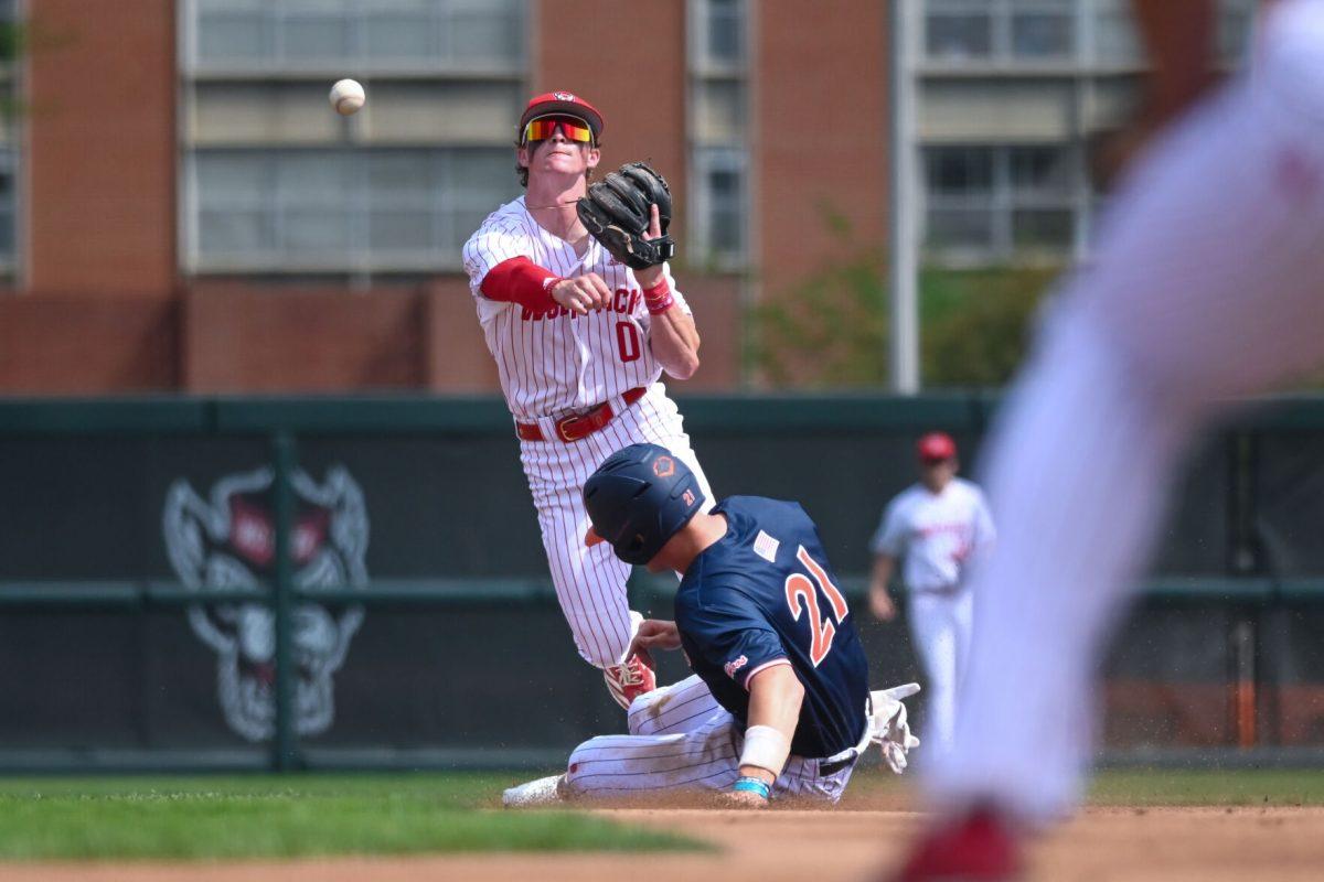 Sophomore infielder Luke Nixon throws to first for a double play during the game against Virginia on April 5, 2025 at Doak Field at Dail Park. Nixon went three for three and one walk. NC State bested Virginia 9-2.