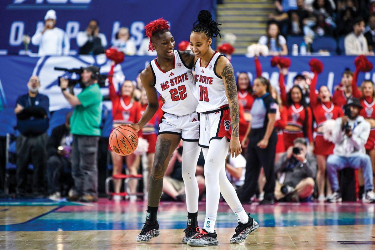 Senior guard Saniya Rivers (left) and senior guard Aziaha James (right) smile during the last moments of the semifinals game of the ACC Tournament against UNC-Chapel Hill in Greensboro Coliseum on Friday, March 7, 2025. NC State won the game 66-55.