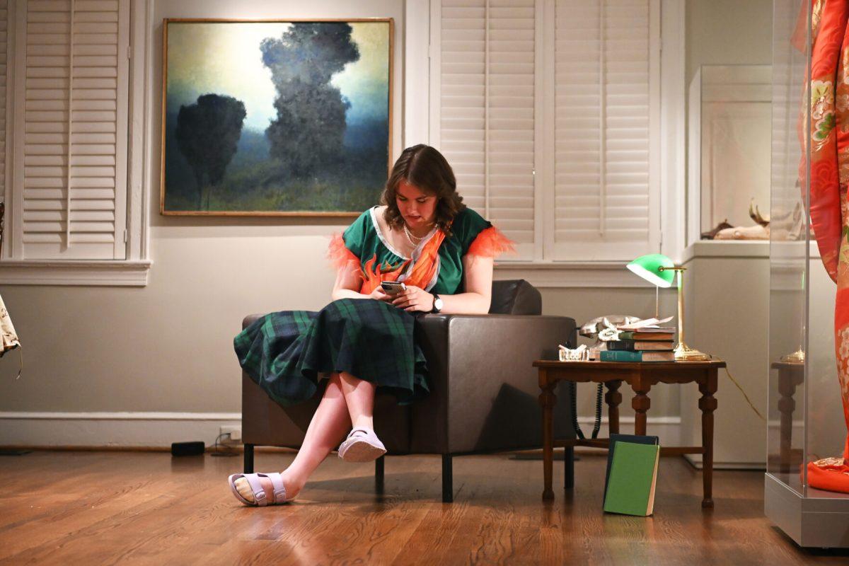Charlotte Davis, a fourth-year studying graphic and experience design, models her piece &#8220;Ignite&#8221; during the Art2Wear: Revive! show at the Gregg Museum of Art and Design. Davis&#8217; design portrays a housewife rebelling against the rigid expectations of women in the 1950s. The smoke and fire on her dress is symbolic of the woman&#8217;s suppressed rage.
