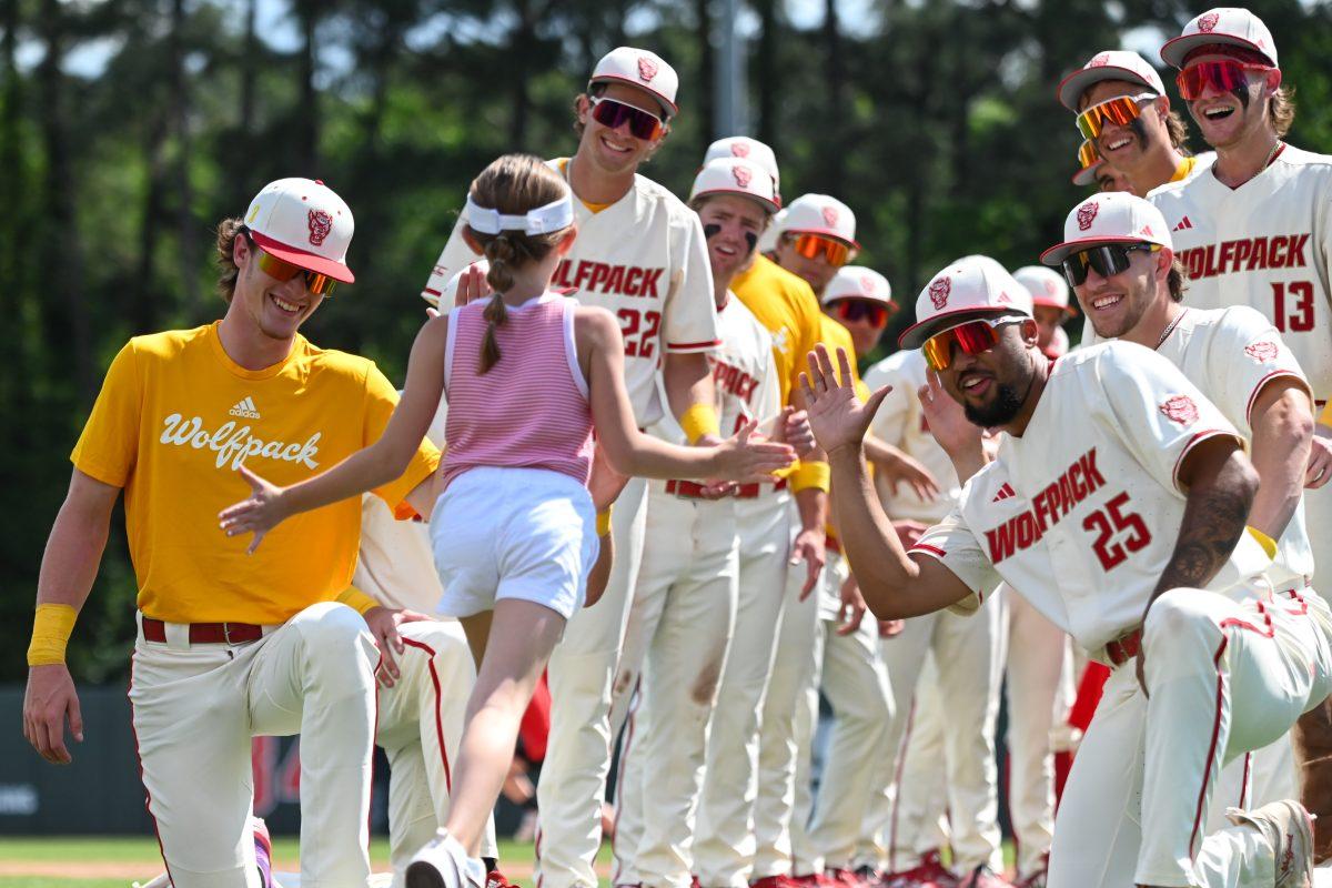 NC State players create a tunnel for kids in attendance to run the bases after the game against Clemson at Doak Field at Dail Park on Saturday, April 26, 2025. NC State raised $17,465 for the V Foundation. The Wolfpack beat the Tigers 4-1.