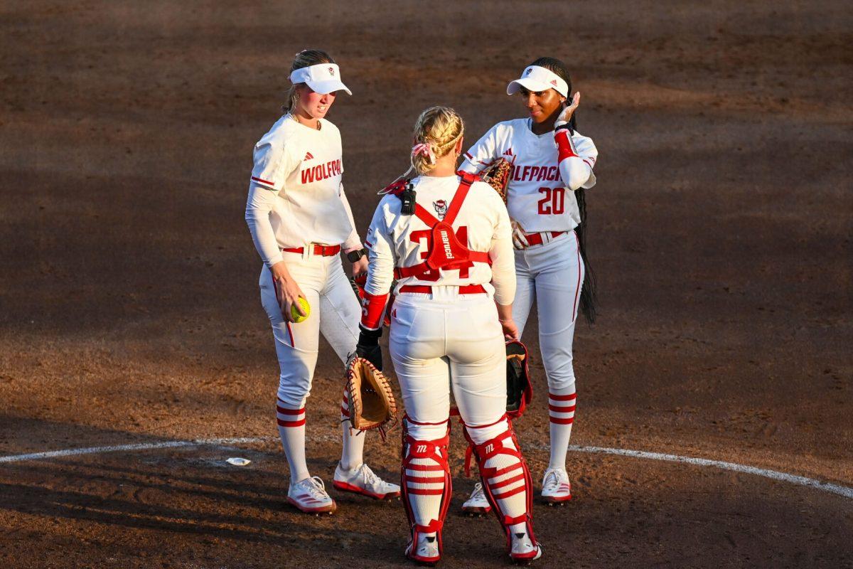Junior pitcher Rylee Wyman (left), redshirt senior catcher Payden Bordeau (center) and junior utility player MaKayla Marbury (right) speak during the game against Virginia Tech at Dail Softball Stadium on Friday, April 5, 2025. NC State lost the game 10-2.