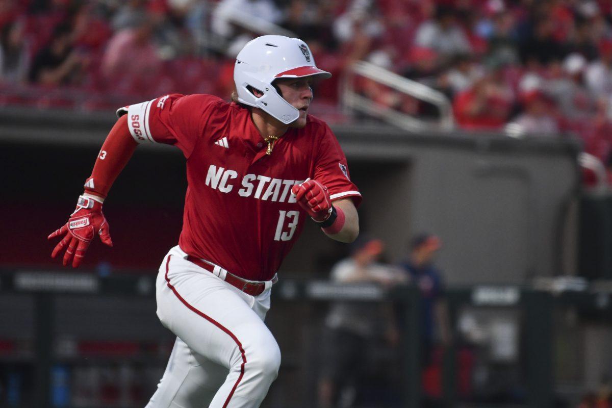 Sophomore catcher Alex Sosa runs to first after a hit during the Wolfpack's home game against the Virginia Cavaliers on Doak Field at Dail Park on Friday, April 4, 2025. Sosa had one hit for one run and one runner batted in. The Cavaliers beat the Wolfpack 8-6 to take the first game of the series.