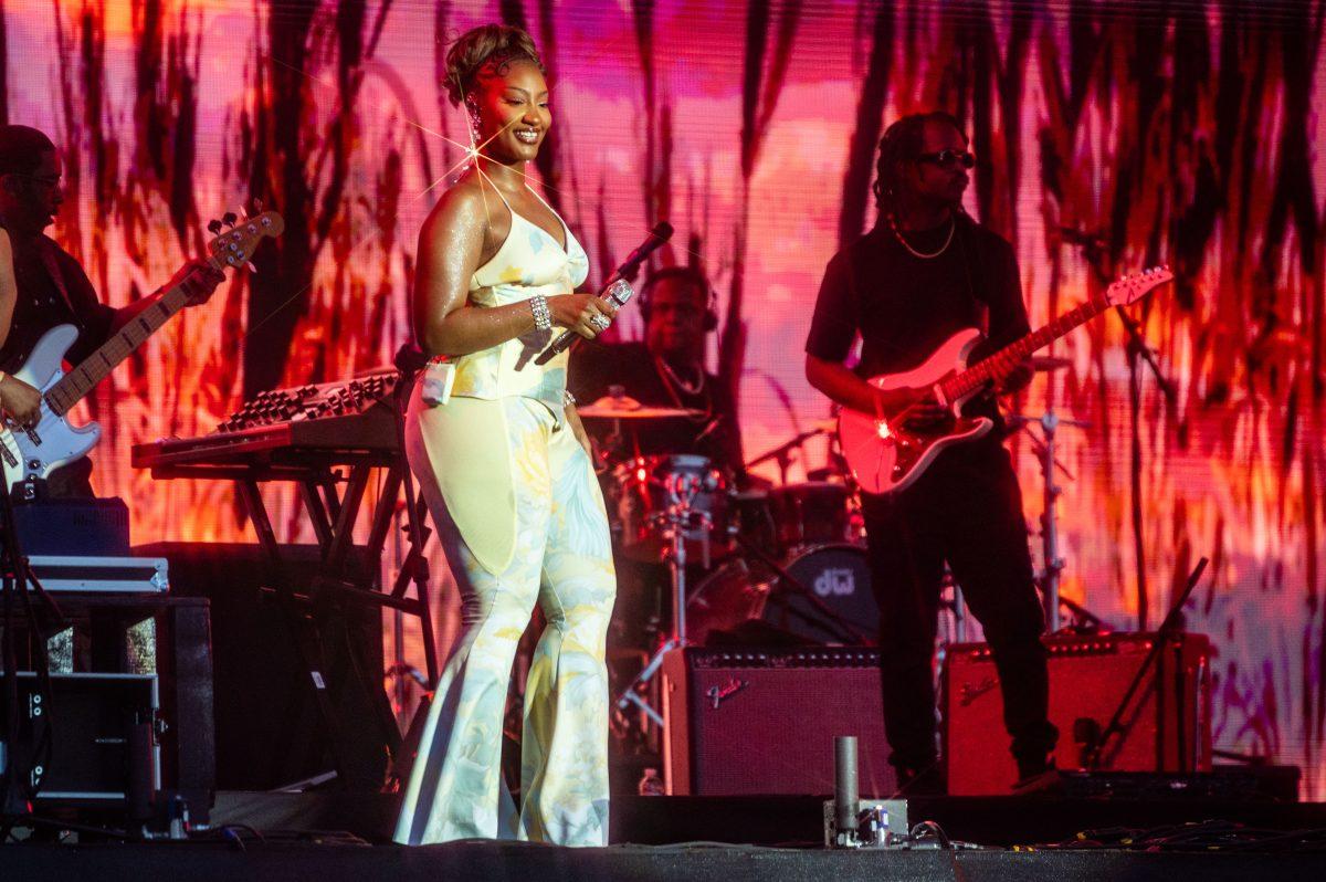 Tems smiles at the crowd during the final Dreamville Festival in Dorothea Dix Park on April 6, 2025. Tems has won Grammys for her work on Future's "Wait for U" and for her own song "Love Me JeJe" from her debut album Born in the Wild (2024).