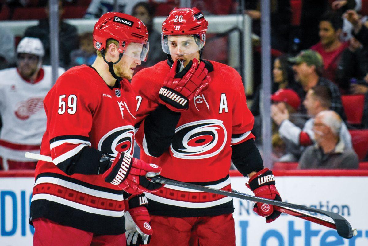 Centers Jake Guentzel and Sebastian Aho talk during a break in the game against the Detroit Red Wings in PNC Arena on Thursday, March 28, 2024. The Hurricanes defeated the Red Wings 4-0.