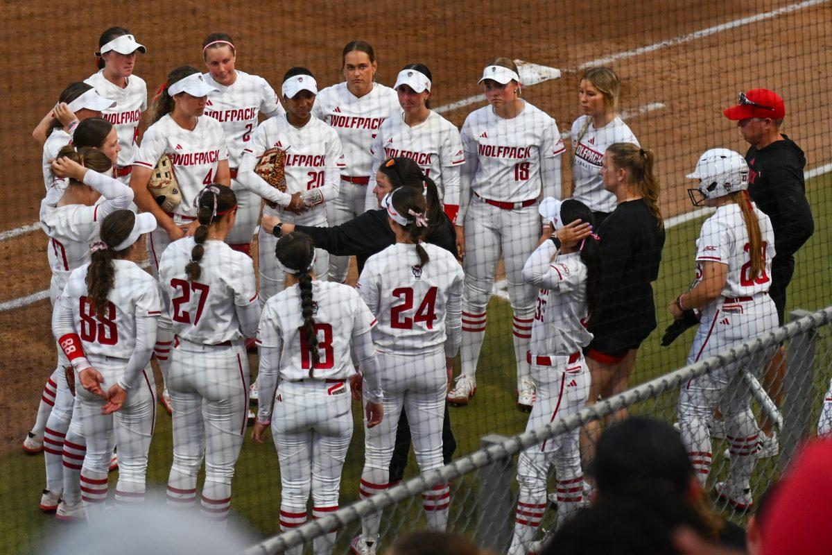 Head coach Lindsay Leftwich (center) speaks to her team during the game against Virginia Tech at Dail Softball Stadium on Friday, April 5, 2025. NC State lost the game 10-2.