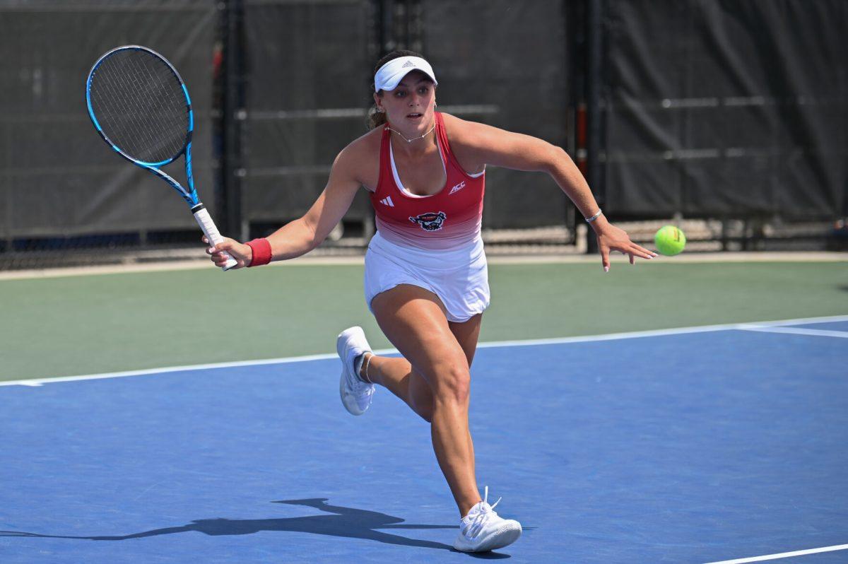 Sophomore Gabriella Broadfoot lunges for the ball during the ACC semifinals match against UNC-Chapel Hill at Cary Tennis Park on Saturday, April 19, 2025. The Wolfpack fell to the Tar Heels 4-1.&#160;