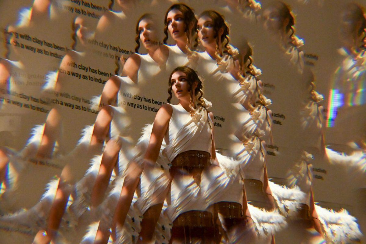 Lauren Nance, a second-year studying fashion and textile management, models Mia Potter and Devyn Williams' piece from The Fall of Icarus during Art2Wear: Revive at the Gregg Museum of Art &amp; Design on Thursday, April 24, 2025. Instead of a traditional fashion runway, Art2Wear displayed the wearable artwork through performance art done by the artists and models.