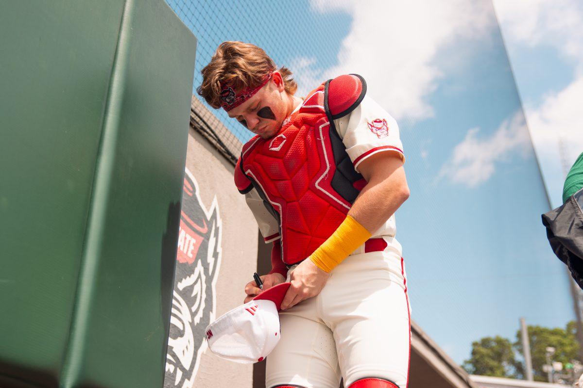 Sophomore catcher Alex Sosa signs a hat for a fan before the 2nd annual "Victory over Cancer" game at Doak Field at Dail Park on Sunday, April, 27, 2025. Sosa hit two homers during the series versus Clemson. NC State beat Clemson 4-1.