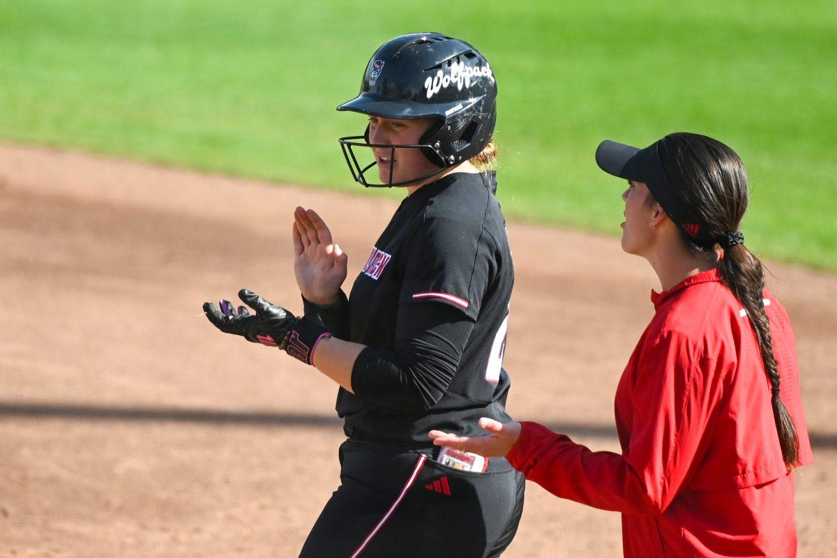 Junior catcher Hannah Church claps after hitting a single during the first game of the doubleheader against Longwood at Dail Softball Stadium on Tuesday, April 15, 2025. NC State lost the game 1-0.