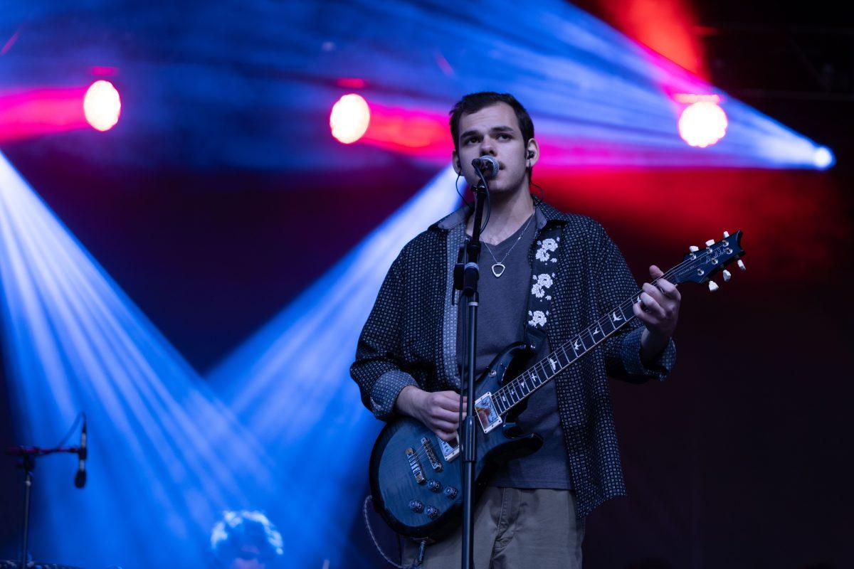 Lead singer of Pilot Light Sam Coury looks out at the crowd as he sings during Wolfstock on Miller Fields on Saturday, April 12, 2025. Pilot Light is a recently formed band made up of Coury, Ethan Johnson, Mason Stark and Chaandmon.