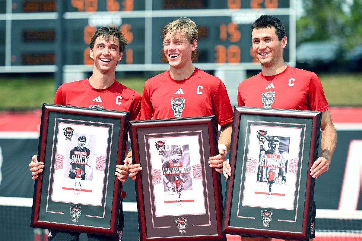 Seniors Braden Shick, Fons Van Sambeek, and Luca Staeheli smile during their Senior Day ceremony after the match versus SMU at J.W. Isenhour Tennis Center on Sunday, April 6, 2025. The Wolfpack beat the Mustangs 4-1.