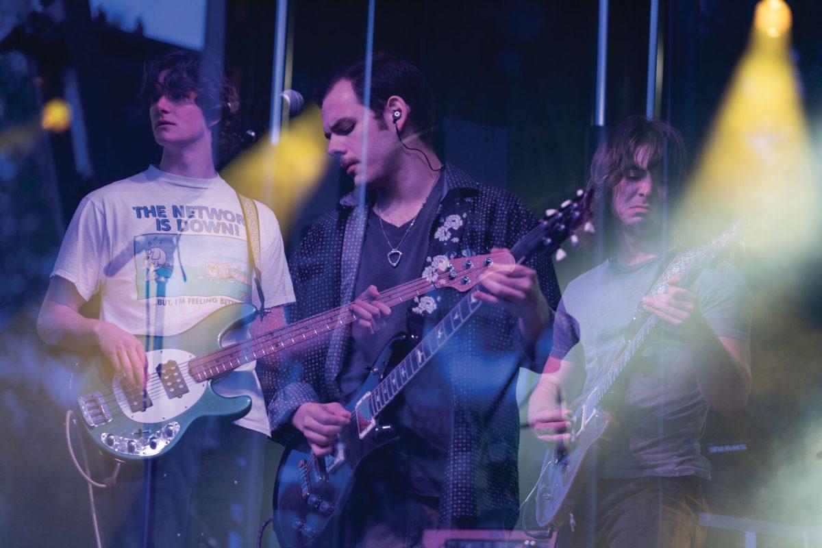 Members of Pilot Light Ethan Johnson, Sam Coury and Mason Stark play during Wolfstock on Miller Fields on Saturday, April 12, 2025. Pilot Light opened for indie band Peach Tree Rascals.