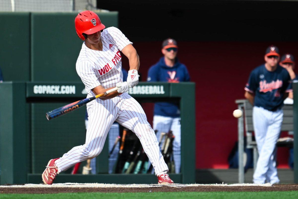 Sophomore infielder Chris McHugh swings while up at bat during the game against Virginia at Doak Field at Dail Park on Saturday, April 5, 2025. The Wolfpack beat the Cavaliers 9-2.