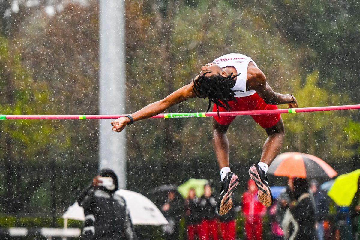 Freshman jumper Christian Hackett jumps over the high jump pole during the Duke Invitational at the Morris Williams Stadium on Friday, April 11, 2025. Hackett tied for eighth with a height of 1.96 meters.