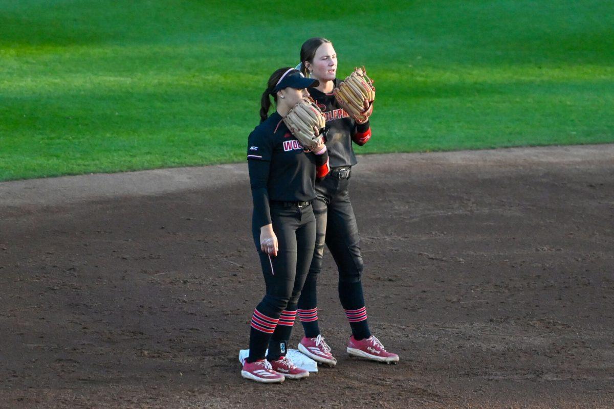 Freshman infielder Kendall Simmers and junior infielder Teagan Thrunk talk at second base during the second game of the doubleheader against Longwood at Dail Softball Stadium on Tuesday, April 15, 2025. NC State won the game 7-0.