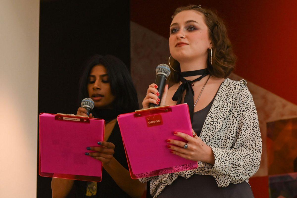 Keerthi Nagapudi, a fourth-year studying design studies and co-student director, speaks to the crowd with Lydia Spears, a fourth-year studying art and design and co-student director during Art2Wear: Revive at the Gregg Museum of Art &amp; Design on Thursday, April 25, 2025. Instead of a traditional fashion runway, Art2Wear displayed the wearable artwork through performance art done by the artists and models.